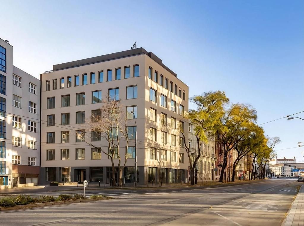 The modern building on Námestie 1. mája where the HEUHAUS apartments are located